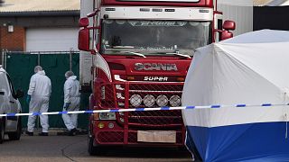 Image: Police officers in a forsensic suits at the scene of a lorry found t