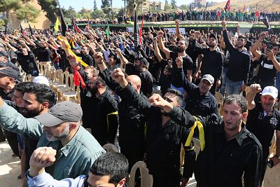 Supporters of Lebanon\'s Hezbollah leader Sayyed Hassan Nasrallah gesture as they listen to his televised speech in Baalbeck, Lebanon Oct. 19, 2019.