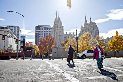 People walk past Temple Square in Salt Lake City on Oct. 23, 2019.