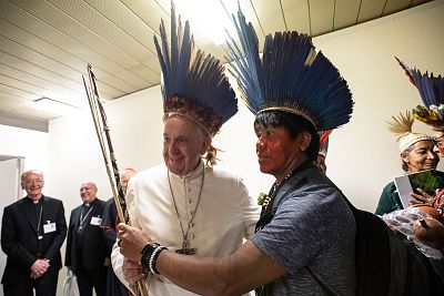 Pope Francis wearing a headdress made of feathers meets with representatives of some of the Amazon\'s different ethnic groups.