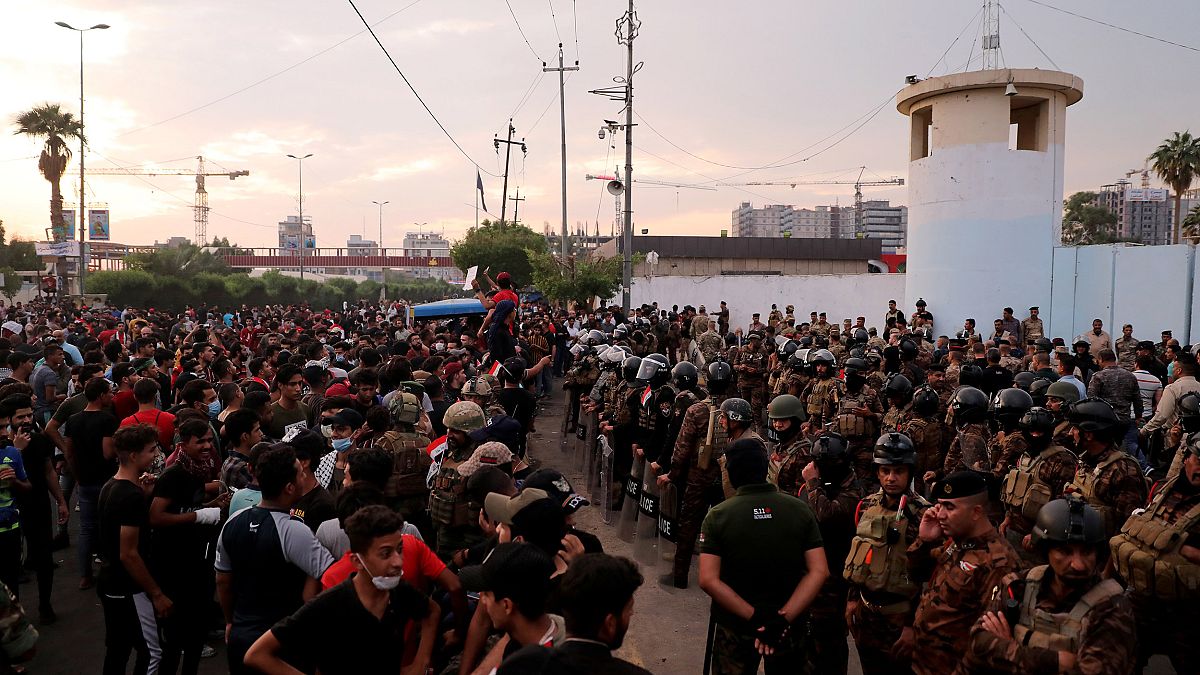 Image: Demonstrators are seen in front of Iraqi security forces near Kerbal
