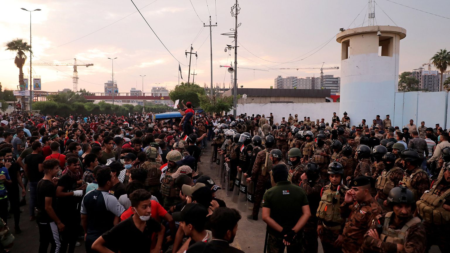 Image: Demonstrators are seen in front of Iraqi security forces near Kerbal