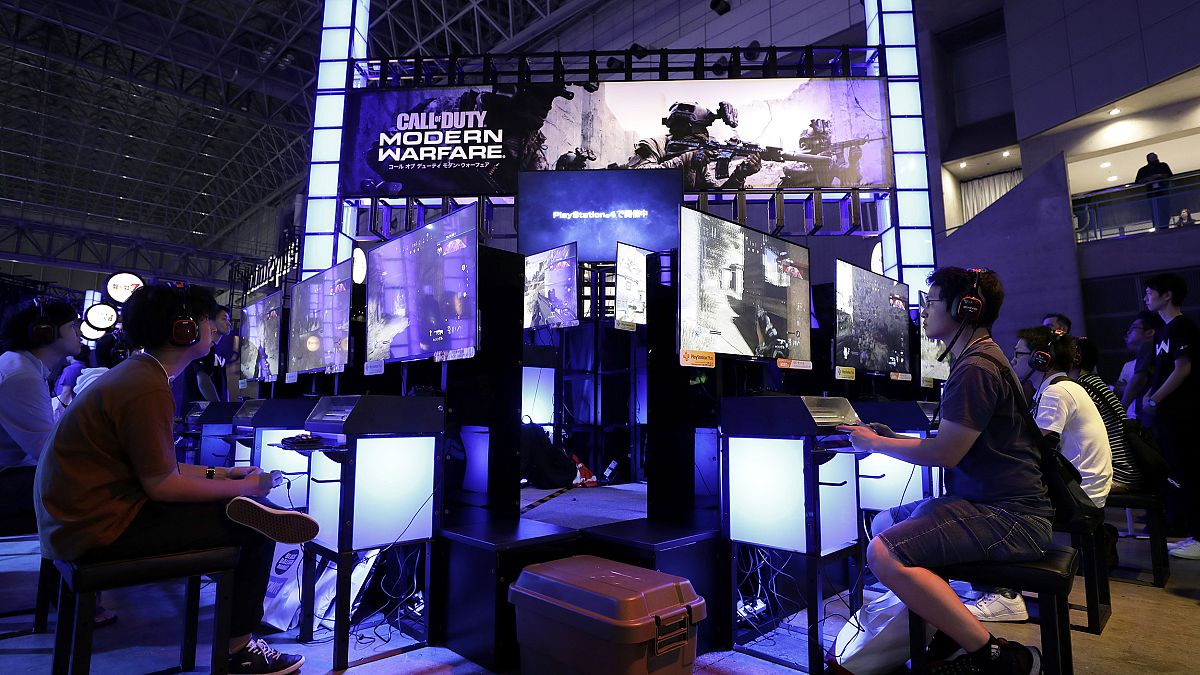 Image: Attendees use Sony Corp. PlayStation 4 (PS4) game consoles to play t