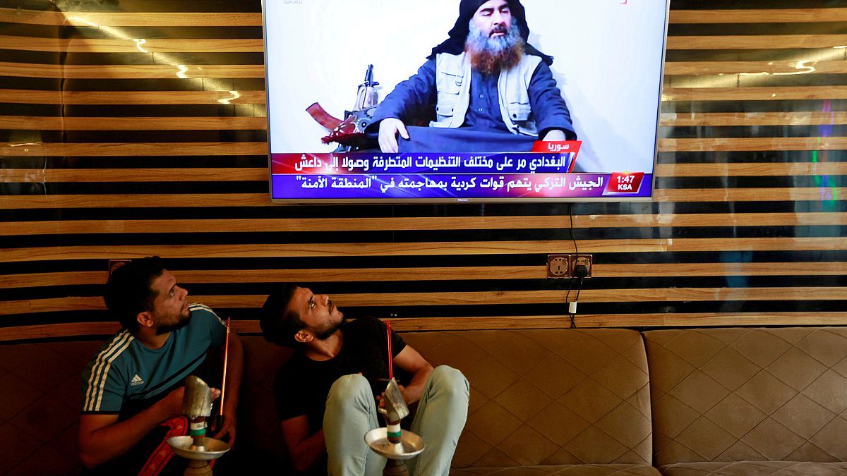 Image: Iraqi youth watch the news of Islamic State leader Abu Bakr al-Baghd
