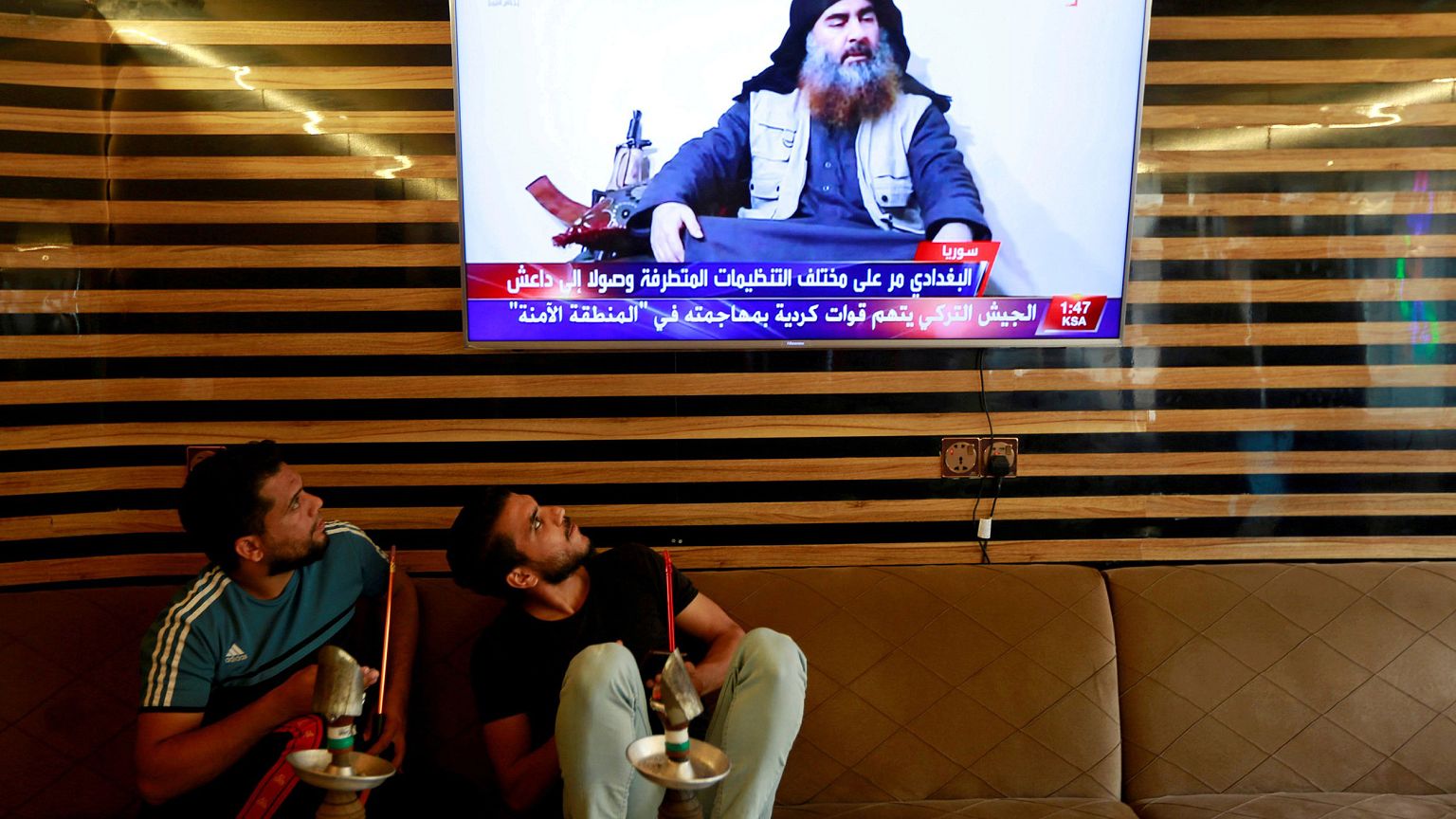 Image: Iraqi youth watch the news of Islamic State leader Abu Bakr al-Baghd