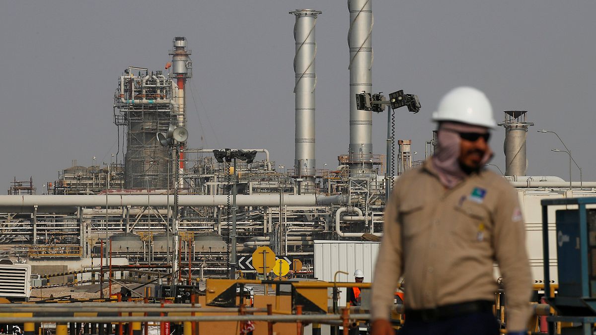 Image: An employee looks on at Saudi Aramco oil facility in Abqaiq