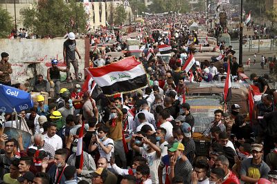 Anti-government protesters march close to the Joumhouriya Bridge that leads to the Green Zone government area, during ongoing protests in Baghdad, Iraq, Sunday, Nov. 3, 2019.