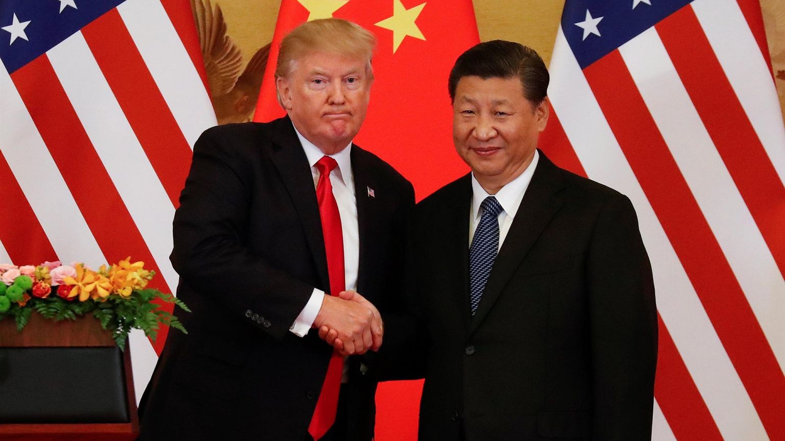 Image: President Donald Trump and China's President Xi Jinping shake hands 