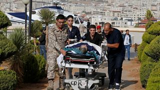 Image: Tourist, who was injured in a stabbing, is brought into King Hussein