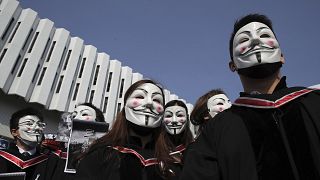 Image: University students wearing Guy Fawkes masks during a protest before
