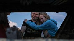 Image: Members of the Lebaron family mourn while they watch the burned car 