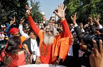 Image: Mahant Dharam Das, chief Priest of Nirmohi Akhara, celebrates after 