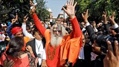 Image: Mahant Dharam Das, chief Priest of Nirmohi Akhara, celebrates after 