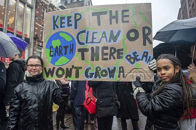 The first young climate strikers in The Netherlands Lilly Platt and Jovanna van den Berg are seen holding a big placard at the beginning of the largest climate strike in the Netherlands, in Dam square, in the center of Amsterdam on March 10.