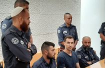 Image: Alexei Burkov, seated second from right, attends a hearing at the Hi