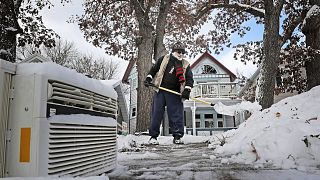 Image: Tom Jacobson shovels snow in Madison, Wis., on Nov. 11, 2019.