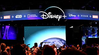 Image:m Attendees visit the Disney  streaming service booth at the D23 Expo