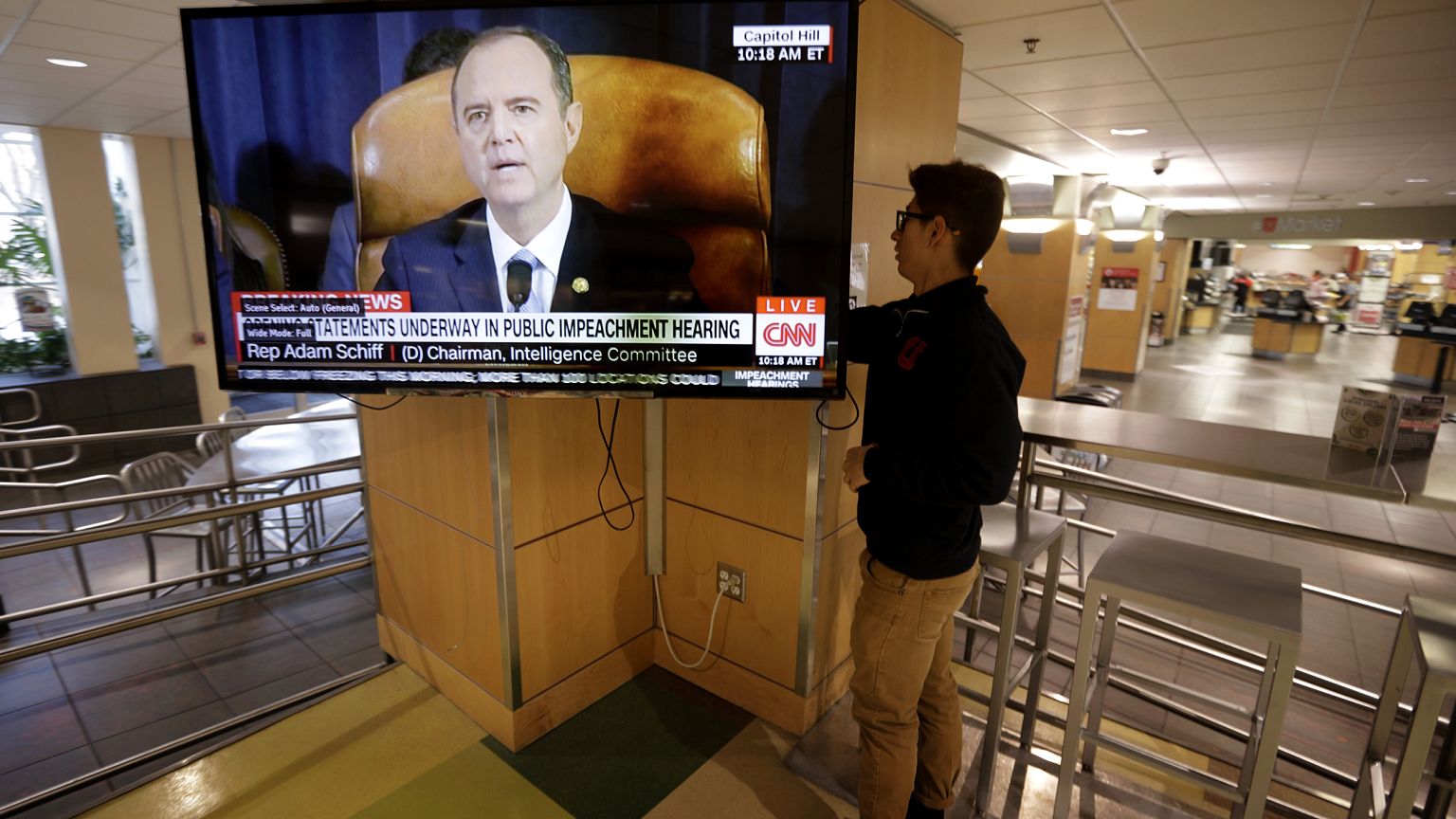 Image: University of Utah student Suyog Shrestha turns on a television at t