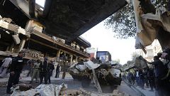 Image: Syrian municipality workers clearing debris from building in Damascu