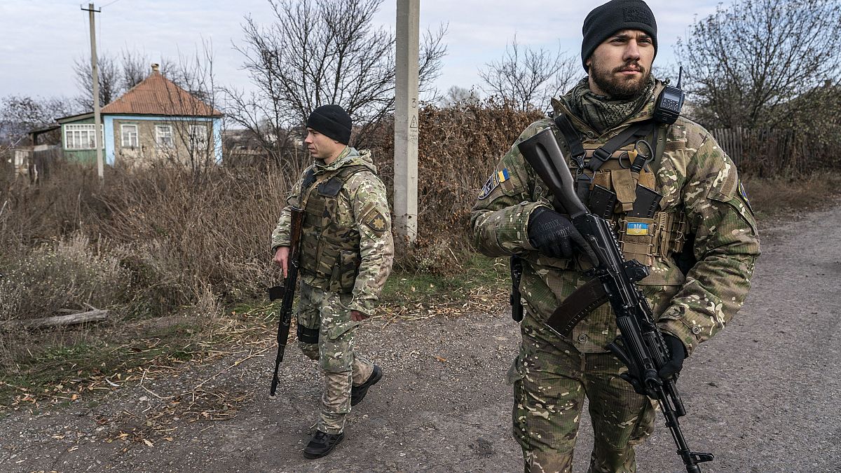 Image: Ukrainian policemen patrol a street near the new line of contact in 
