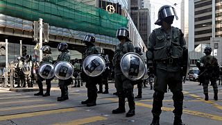 Image: Riot police stand in the middle of a street in Central district in H