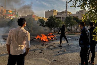Protesters in the central city of Shiraz block a road during a demonstration against an increase in gasoline prices on Saturday.