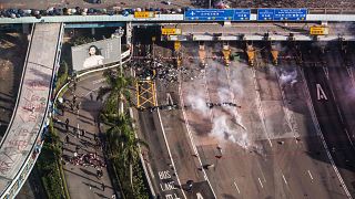 Image: People are detained by police near the Hong Kong Polytechnic Univers