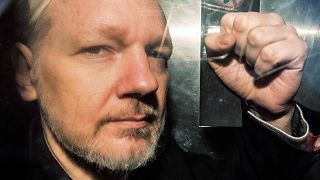 Image: WikiLeaks founder Julian Assange gestures from the window of a priso