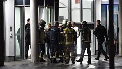 Image: Policemen, firefighters and medical staff stand in front of the hosp