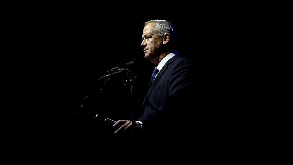 Image: Benny Gantz, head of Blue and White party, speaks during a rally com