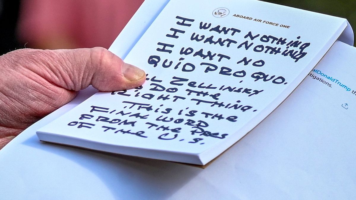 Image: President Donald Trump holds notes on Ambassador Gordon Sondland's t