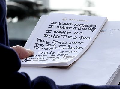 President Donald Trump holds his notes while speaking to the media before departing from the White House on November 20, 2019.
