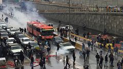 Image: People protest against increased gas price, on a highway in Tehran