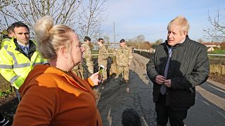Image: Prime Minister Boris Johnson speaks with a local woman during a visi