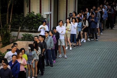 People queue to cast their in Sunday\'s district council election in Hong Kong. 