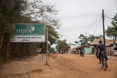 A sign points to the office of one of UNHCR\'s implementing partners in the Nakivale refugee settlement.