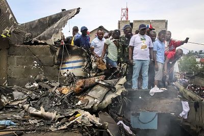 Rescuers and residents gather near debris of a small plane after it crashed in Congo\'s eastern city of Goma on Nov. 24, 2019.