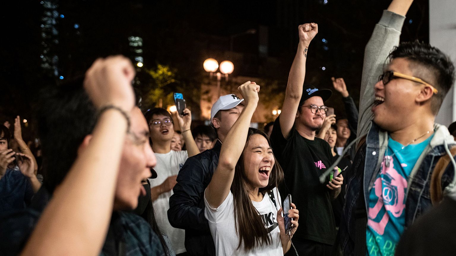 Image: Pro-democracy supporters chant as they celebrate after pro-Beijing c