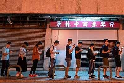 People queue to cast their vote in the district council elections in Tseung Kwan O district of Hong Kong on Sunday. 