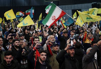 Hezbollah supporters shout slogans and wave Lebanese, Hezbollah and Iran flags during a rally to commemorate the 40th anniversary of Iran\'s Islamic Revolution in southern Beirut on Feb. 6, 2019.