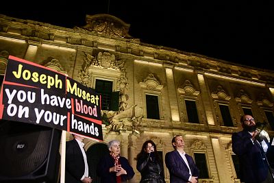Blogger Manuel Delia (R) addresses the crowd of protesters gathered outside the Prime minister\'s office in Valletta, on Nov. 26, 2019 hours after political resignations in the wake of the Daphne Caruana Galizia murder investigation.