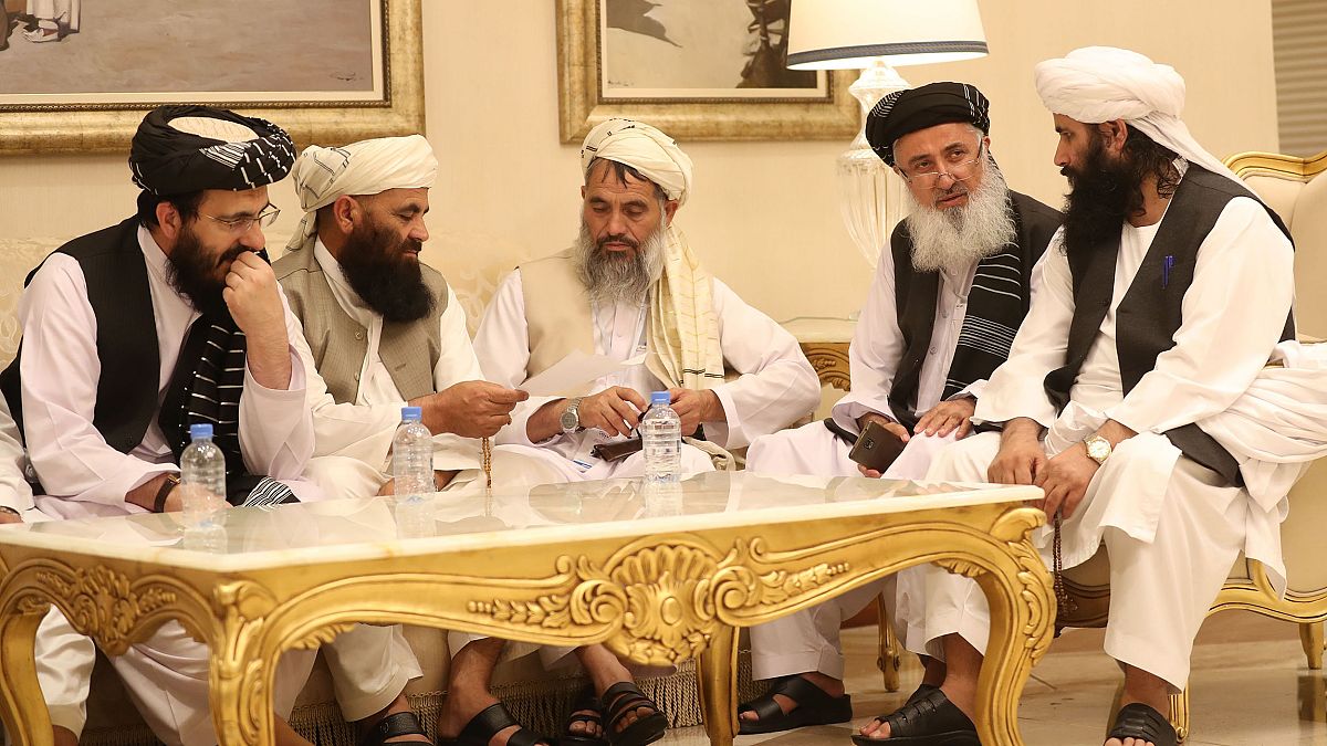 Image: Senior Afghans gather during talks with the Taliban in the Qatari ca