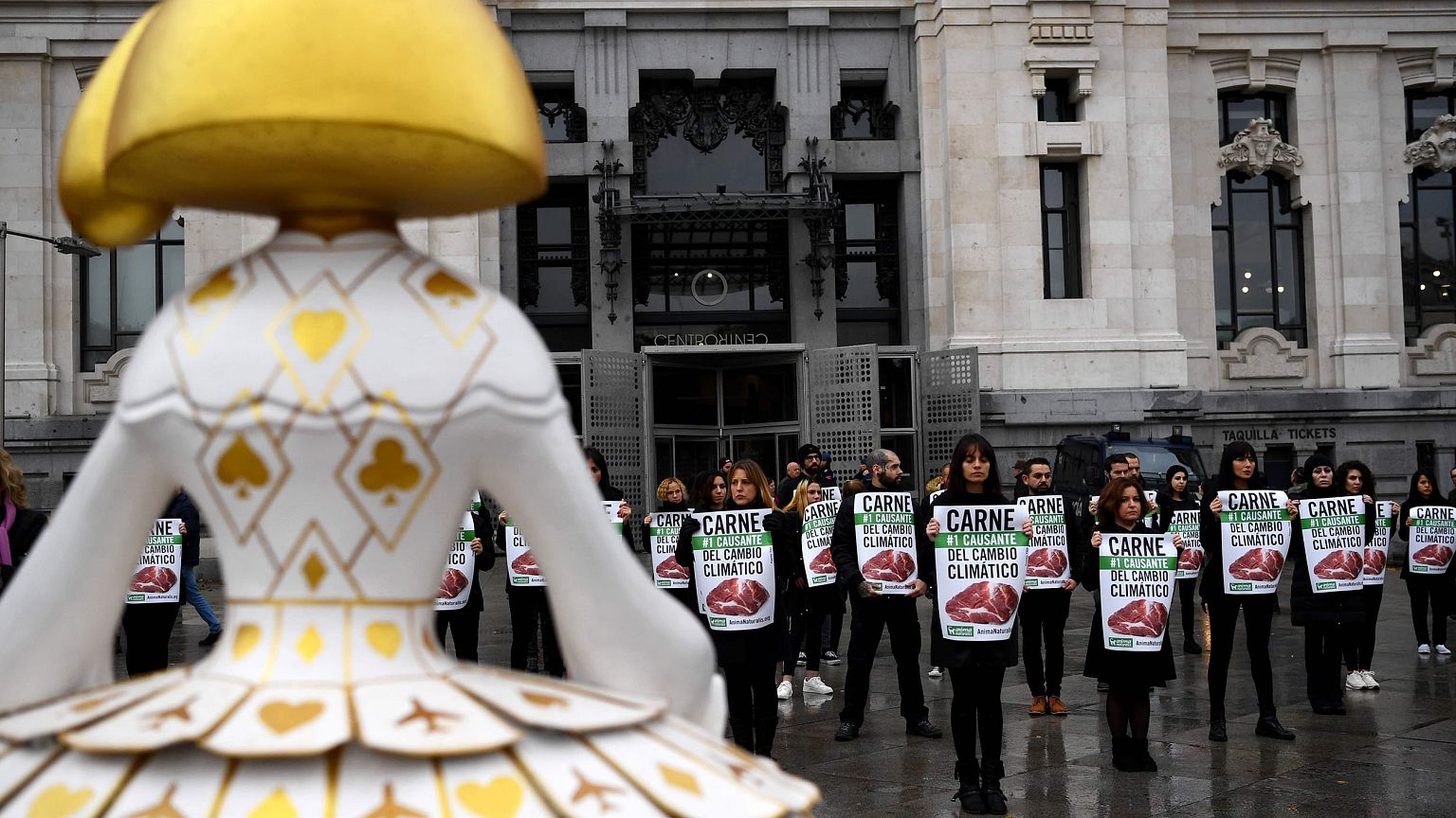Image: Activists hold placards reading "meat is the first cause of climate 