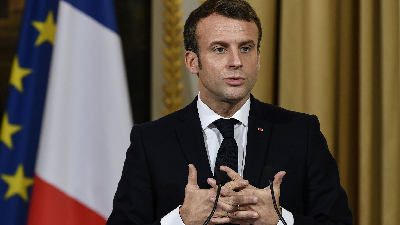 Image: French President Emmanuel Macron gestures during a joint press confe