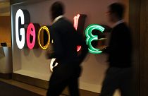 Image: People walk into Google's New York offices