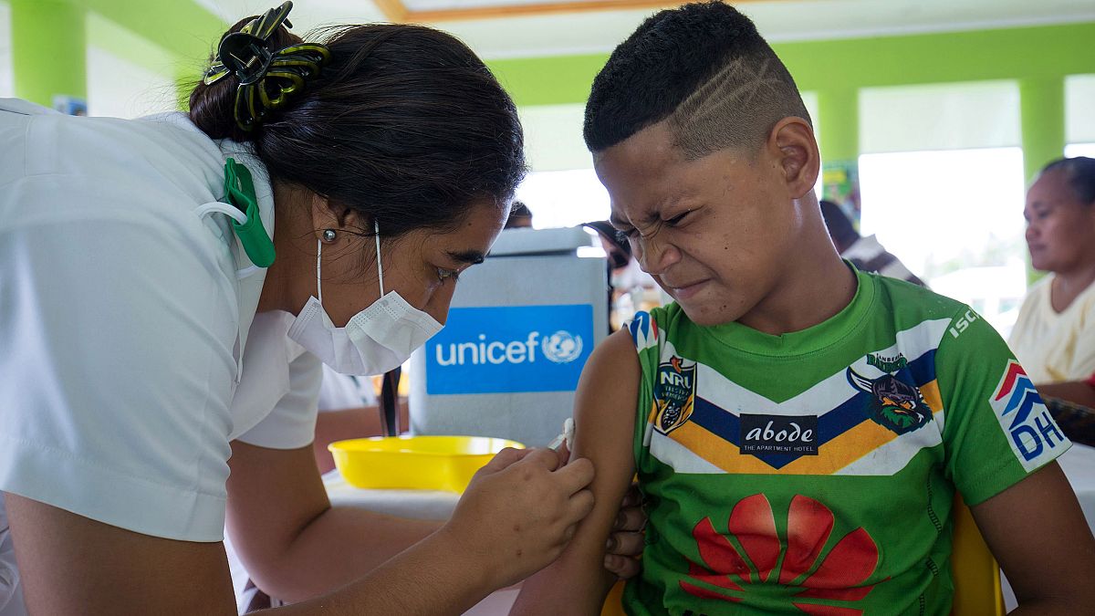 Image: A boy receiving a vaccine during a nationwide campaign against measl
