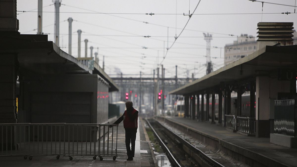 Image: A man stands on a deserted platform at the Gare de Lyon train statio