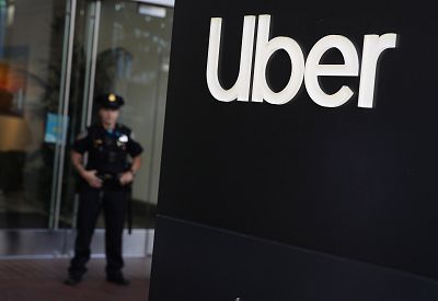 A San Francisco police officer monitors a protest outside of Uber headquarters on Aug. 27, 2019.