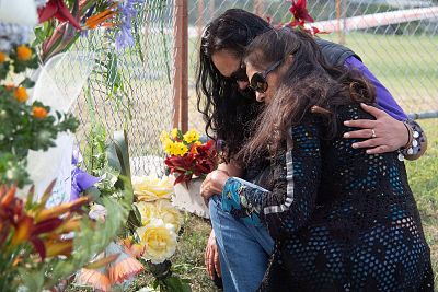 Mourners place flowers on the waterfront near the base of White Island Tours in the Bay of Plenty on Tuesday.