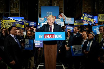 Boris Johnson speaks to supporters at a factory in Manchester, England, on Tuesday.